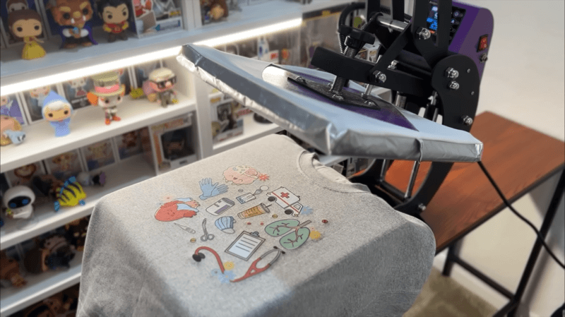 a cool embroidered sweatshirt on a flattening machine