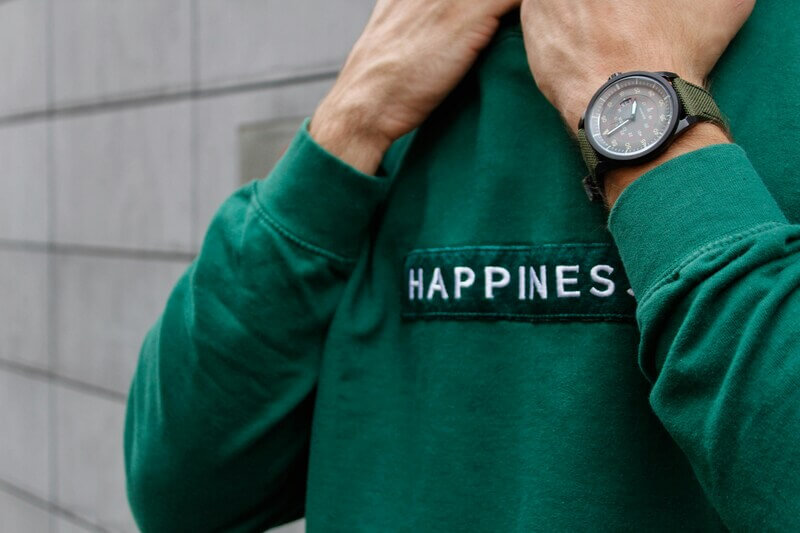 men wearing happiness-embroidered sweatshirt