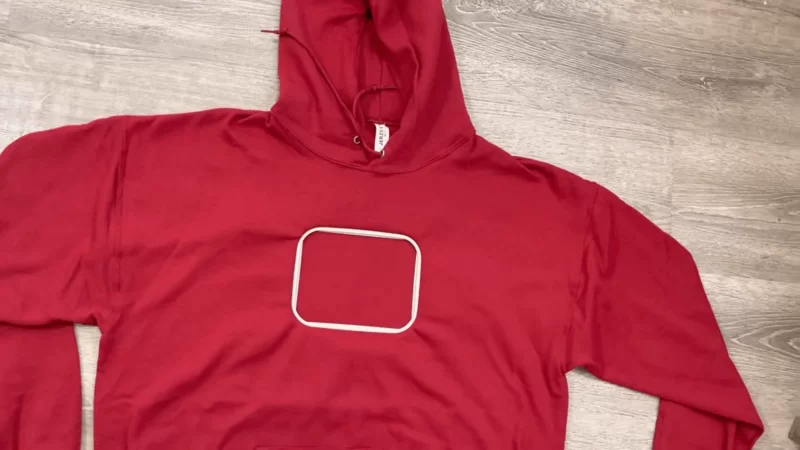 red custom embroidered hoodies on the floor