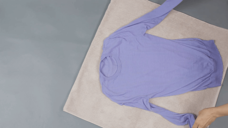 violet sweatshirt laying on the floor