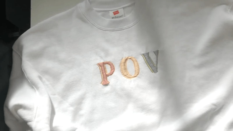 white embroidered sweatshirt pov text